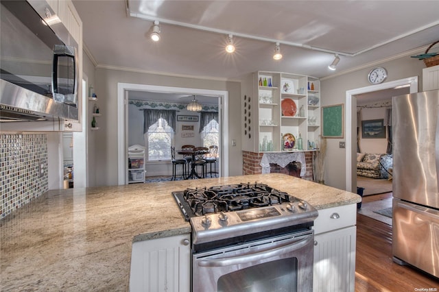 kitchen with white cabinets, light hardwood / wood-style floors, track lighting, and appliances with stainless steel finishes