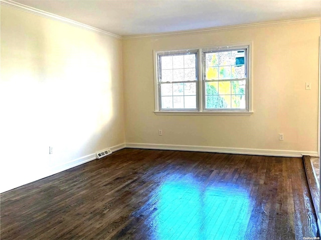 empty room with dark hardwood / wood-style floors and ornamental molding