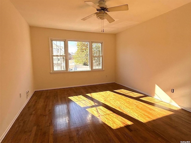 spare room with ceiling fan and dark wood-type flooring