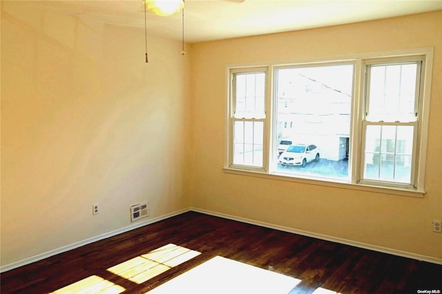 spare room with dark hardwood / wood-style floors