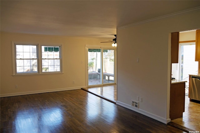 empty room with crown molding, ceiling fan, and dark hardwood / wood-style floors