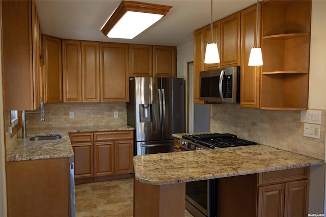 kitchen with kitchen peninsula, light stone countertops, stainless steel appliances, sink, and decorative light fixtures