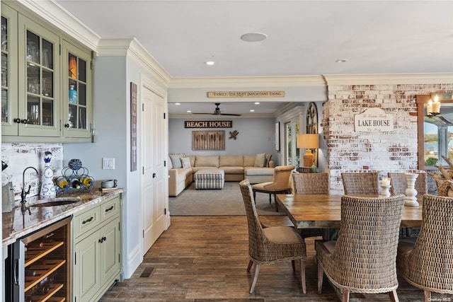 dining area featuring indoor wet bar, dark hardwood / wood-style floors, ornamental molding, and wine cooler