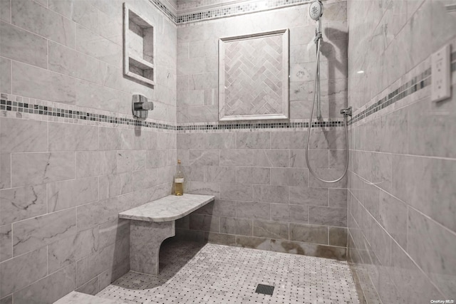 bathroom with tiled shower