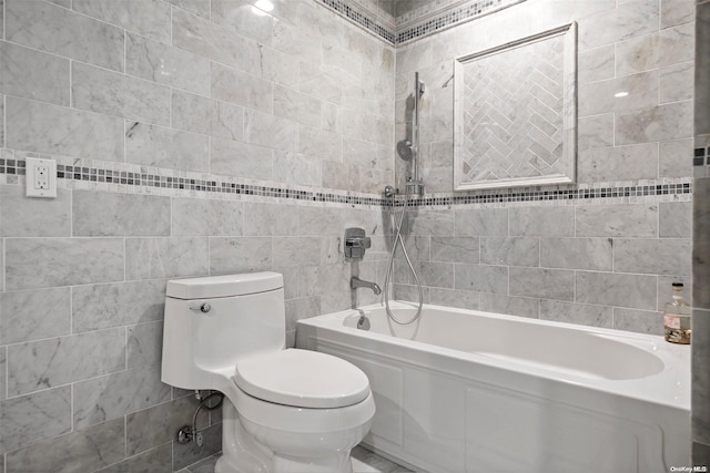 bathroom with toilet, bathing tub / shower combination, and tile walls