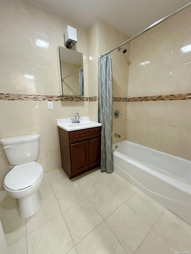 full bathroom featuring tile patterned flooring, vanity, tile walls, and shower / bath combo with shower curtain