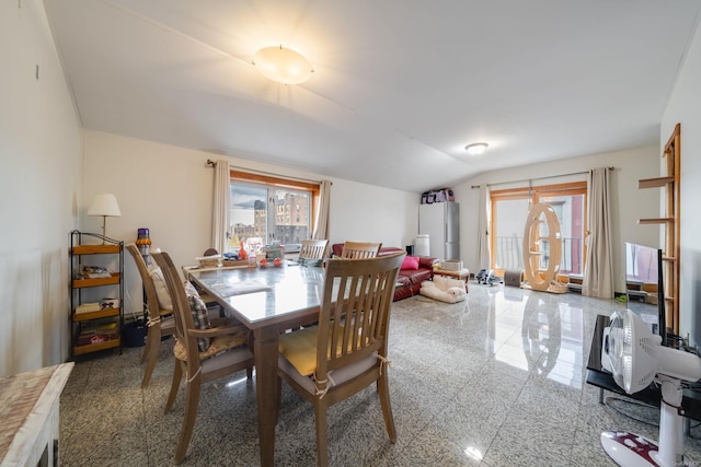 dining room with plenty of natural light and vaulted ceiling