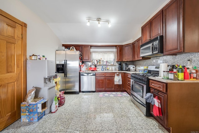 kitchen featuring stainless steel appliances and tasteful backsplash