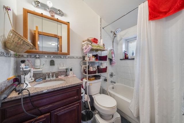 full bathroom with shower / bath combo with shower curtain, vanity, tile walls, and toilet