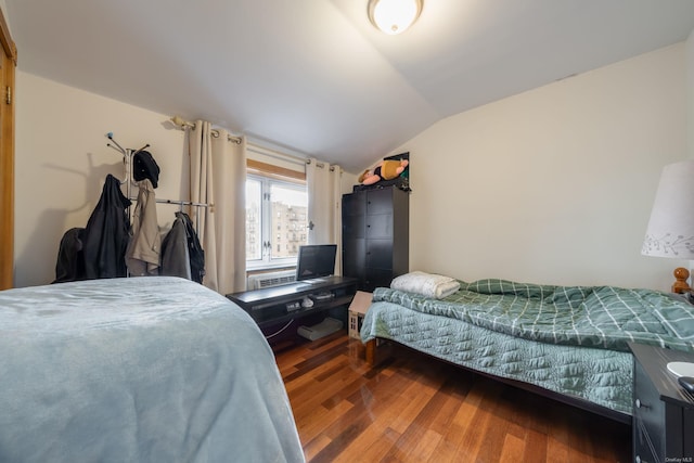 bedroom with dark hardwood / wood-style floors and vaulted ceiling