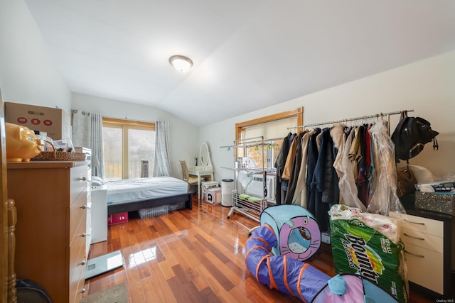 bedroom featuring hardwood / wood-style floors and lofted ceiling