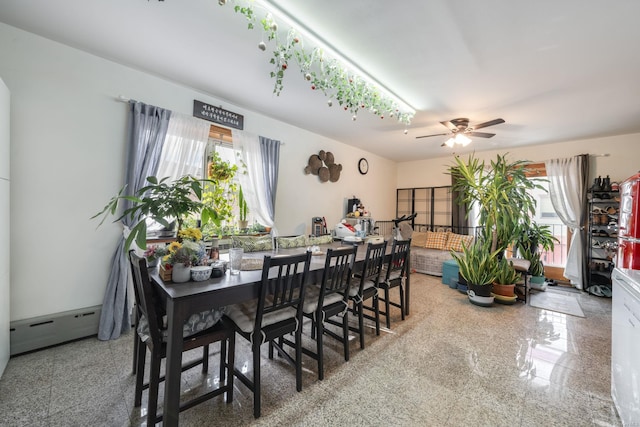 dining room with ceiling fan and a baseboard radiator