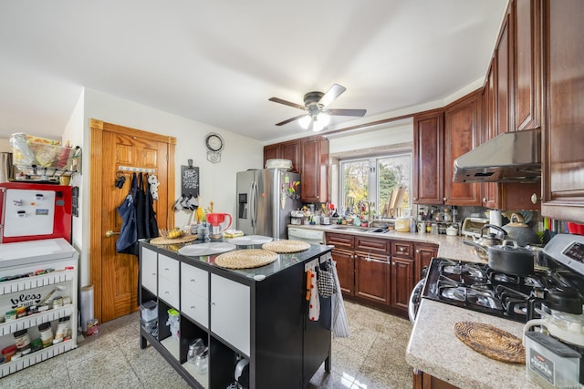 kitchen with exhaust hood, sink, ceiling fan, decorative backsplash, and appliances with stainless steel finishes