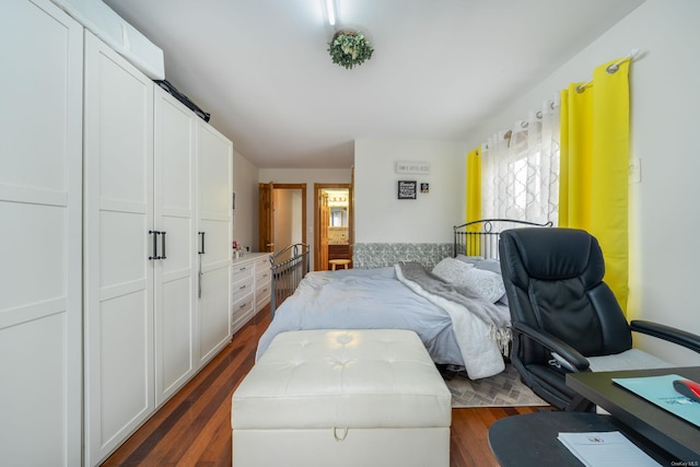 bedroom with dark hardwood / wood-style flooring and a closet