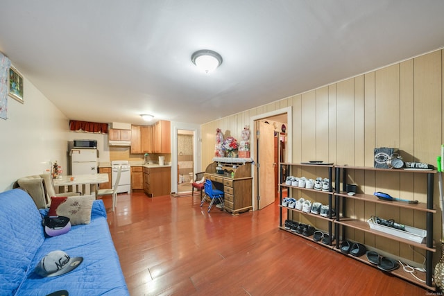 living room featuring hardwood / wood-style floors and wood walls