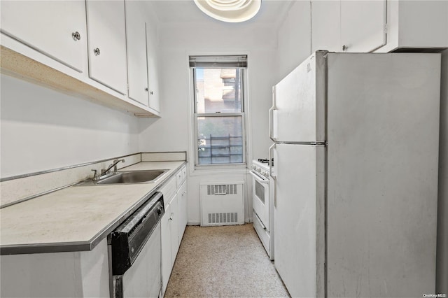 kitchen with white cabinets, radiator heating unit, white appliances, and sink