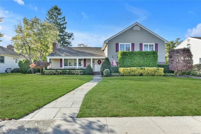 tri-level home with a front lawn