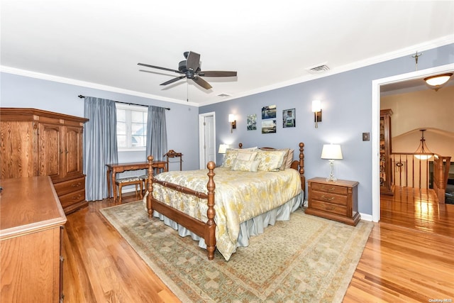 bedroom featuring light hardwood / wood-style floors, ceiling fan, and ornamental molding