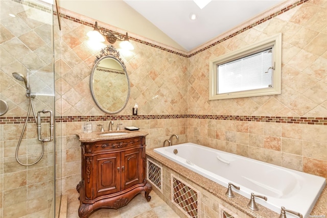 bathroom with vanity, tile walls, and lofted ceiling