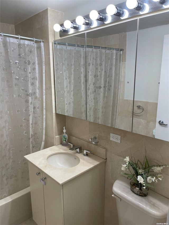 bathroom with decorative backsplash, vanity, tile walls, and toilet