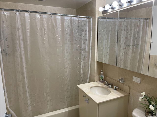 bathroom featuring vanity and tile walls