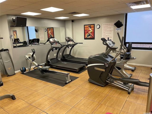 workout area with a paneled ceiling