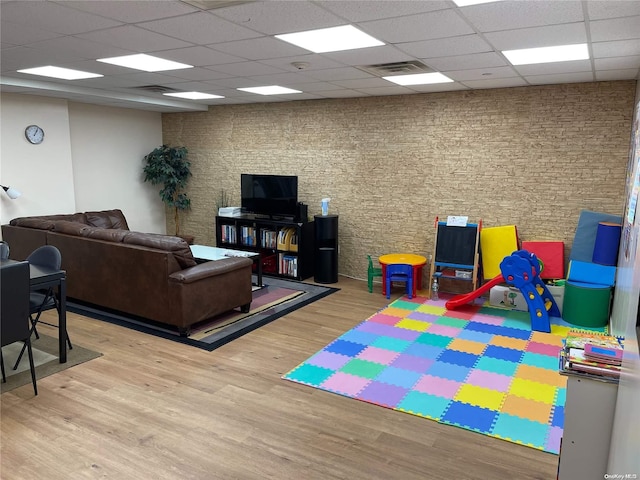 rec room featuring a drop ceiling and light wood-type flooring