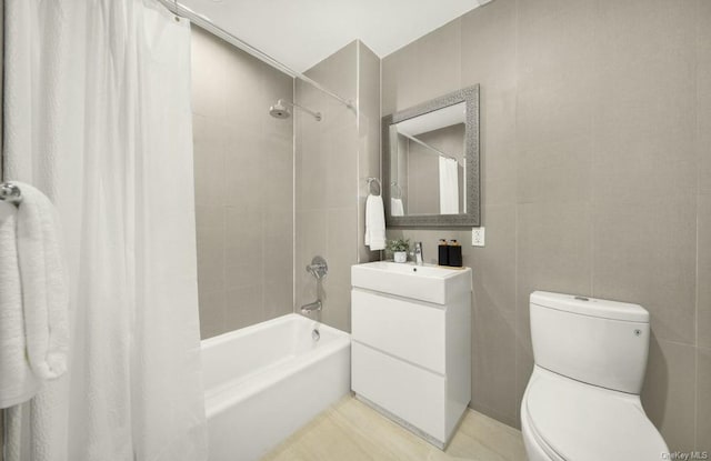 full bathroom with vanity, shower / tub combo, and toilet