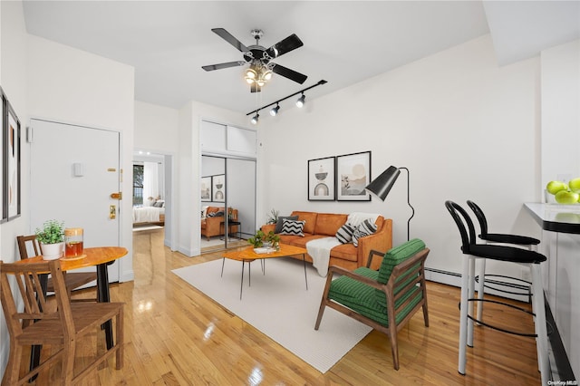 living room featuring ceiling fan, light hardwood / wood-style floors, and track lighting