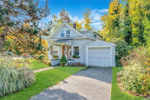 view of front facade with a garage and a front lawn