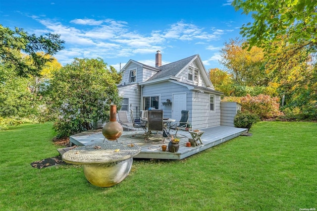 back of house with a lawn and a deck