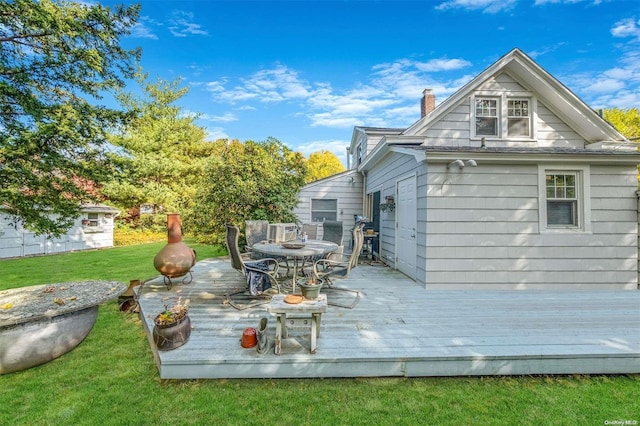 wooden deck featuring a lawn