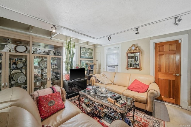 living room with a fireplace, cooling unit, and a textured ceiling