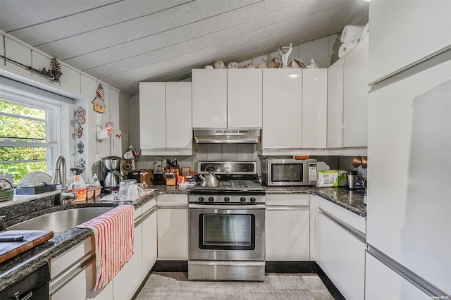 kitchen with sink, white cabinets, lofted ceiling, and appliances with stainless steel finishes