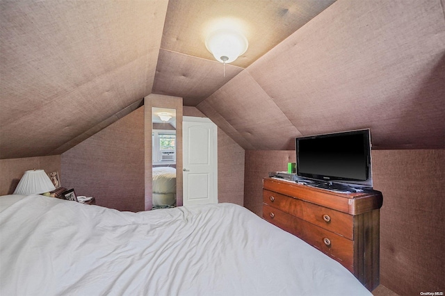 bedroom with lofted ceiling