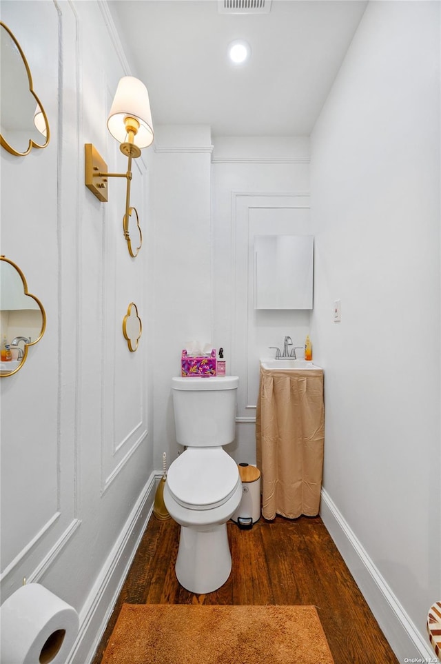 bathroom featuring wood-type flooring and toilet