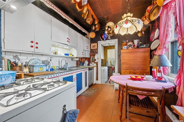 kitchen featuring decorative backsplash, white cabinetry, and sink