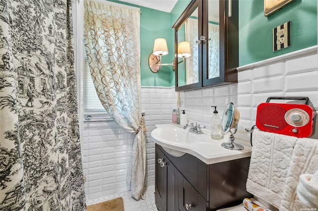 bathroom featuring tile patterned flooring, vanity, and tile walls