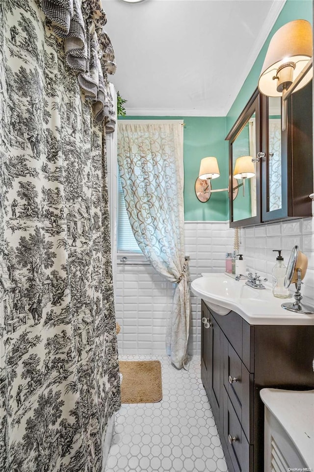 bathroom with plenty of natural light, crown molding, tile walls, and vanity