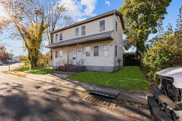 front facade with a front yard