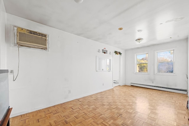 empty room featuring light parquet flooring, a wall unit AC, and baseboard heating