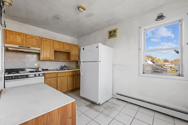 kitchen featuring backsplash, white appliances, sink, a baseboard radiator, and light tile patterned flooring