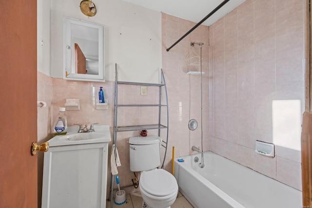 full bathroom featuring tile patterned floors, vanity, tile walls, toilet, and tiled shower / bath