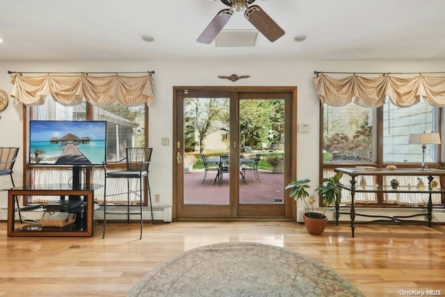 doorway to outside featuring french doors, ceiling fan, baseboard heating, and wood-type flooring