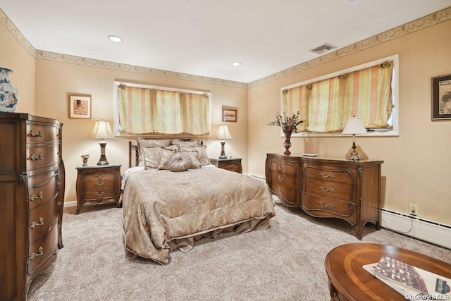 bedroom with light carpet and a baseboard radiator