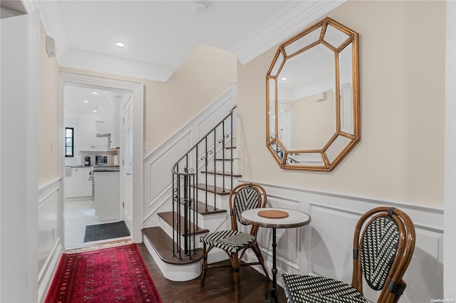 interior space with hardwood / wood-style floors and crown molding