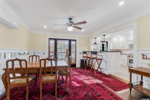 dining space with light hardwood / wood-style flooring, ceiling fan, crown molding, and a wall unit AC