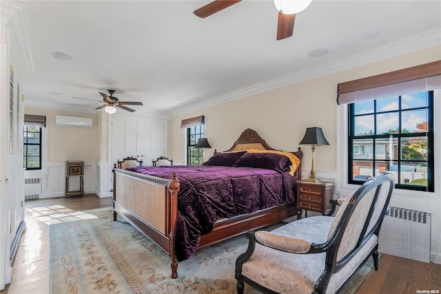 bedroom featuring radiator, light hardwood / wood-style flooring, a wall mounted AC, and ornamental molding