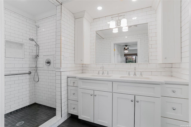 bathroom featuring tiled shower, vanity, and tasteful backsplash