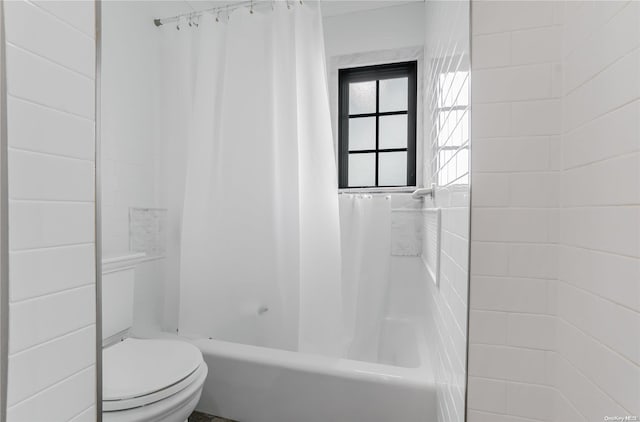 bathroom featuring toilet and shower / bathtub combination with curtain